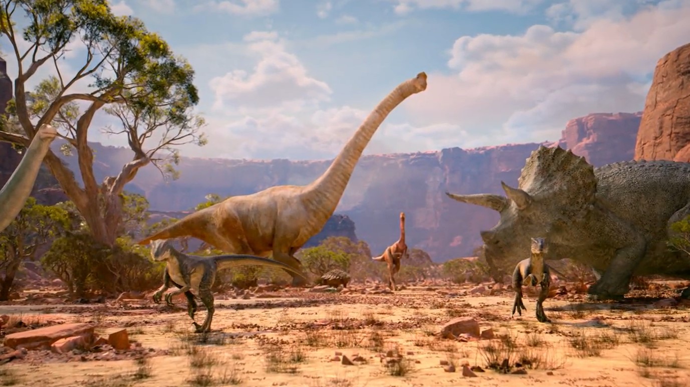 Una imagen en la que vemos un par de brontosaurios, un triceratops, un para de velociraptores y yo qué sé más.